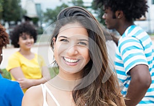 Joyful laughing caucasian woman with large group of international students