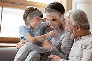 Joyful laughing different generations carefree family having fun indoors.