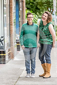 Joyful lesbian couple standing outdoors