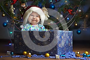 Joyful little baby in the present box