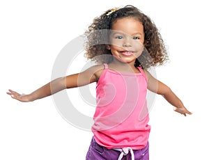 Joyful little girl with an afro hairstyle laughing with her arms extended