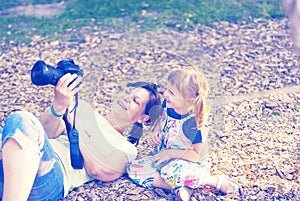 Joyful little girl with her happy mother are make photo