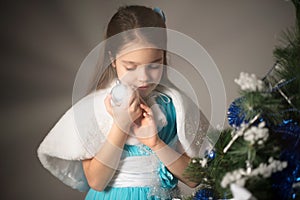 Joyful little girl holding a ball