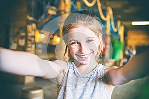 Joyful little girl making selfie