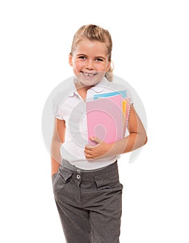 Joyful little girl standing on white with few colorful notebooks