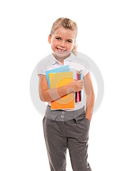 Joyful little girl standing on white with few colorful notebooks