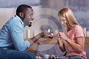 Joyful man making proposal to his future wife