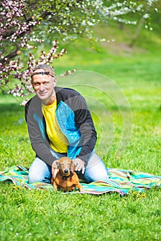 Joyful man plays with his funny dog