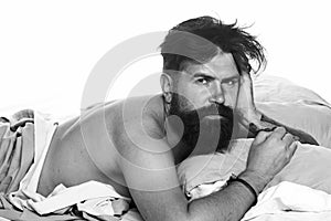 Joyful man sleeping on a bed. Man bearded hipster having problems with sleep. Violations of sleep and wakefulness.