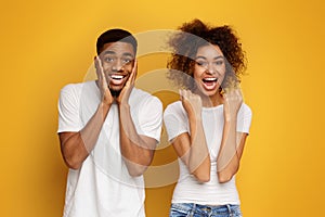 Joyful millennial african american couple rejoice success