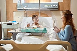 Joyful mother and daughter communicate in a hospital ward