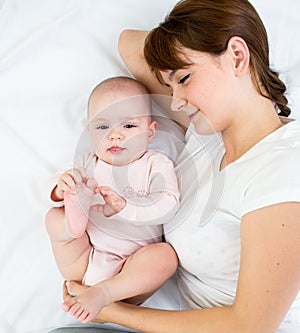 Joyful mother looking at her baby infant