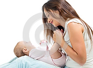 Joyful mother playing with her baby infant
