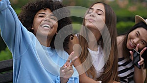 Joyful multi ethnic selfie girls having fun outdoor