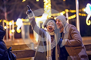 Joyful multiethnic couple exploring the city; Holiday joy concept