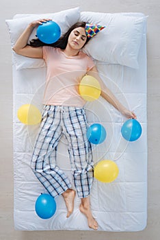 Joyful nice woman being surrounded by balloons