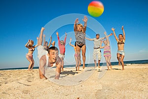 Joyful people playing volleyball