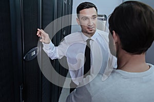 Joyful pleasant man speaking with his colleague