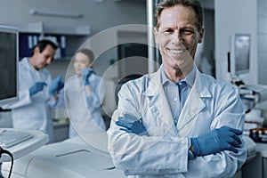 Joyful positive man standing cross handed