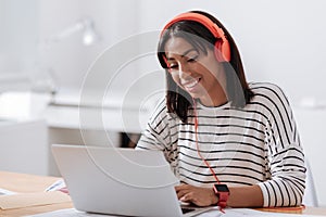 Joyful positive woman working on a laptop