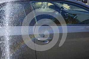 A water rainbow sparkled from splashing during a car wash photo