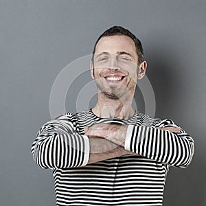 Joyful 40s man folding his arms in front of him photo