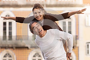 Joyful Senior Couple Having Fun Posing, Husband Carrying Wife Outdoors