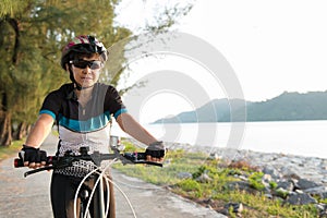 Joyful senior woman riding a bicycle