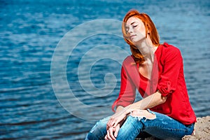 Joyful serene redhead woman sitting comfortably photo