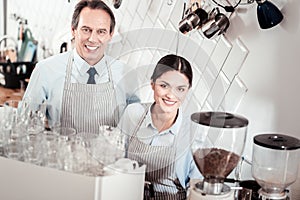 Joyful skilled baristas working