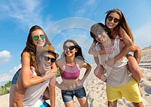 Joyful smiling friends having fun on the beach