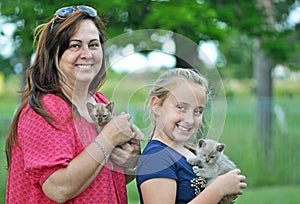 Joyful smiling mom & daughter & new pet kittens
