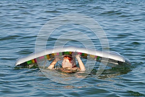 Joyful smiling teenage girl bathes with air mattress in the sea