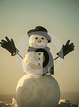 Joyful snowman. Snowman gentleman in winter black hat, scarf and gloves.