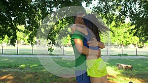 Joyful sporty couple meeting during outdoors workout