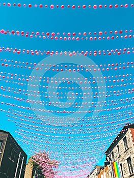 Joyful street in gay neighborhood decorated with pink balloons