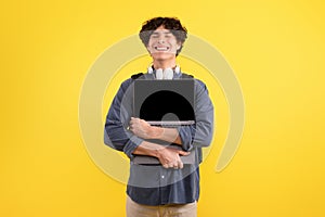 Joyful Student Guy Hugging Laptop Computer Posing Over Yellow Background