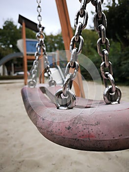 A joyful swing on kids playground on summer