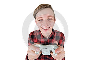Joyful teen boy playing video games isolated over white background