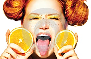 Joyful teen girl with juicy oranges. Freckles photo