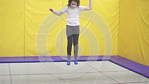 Joyful teenager girl jumping on a trampoline