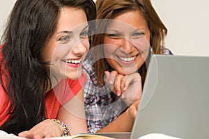 Joyful teens browsing on internet photo