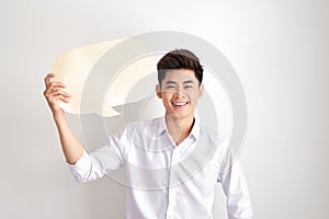 Joyful thinking man holding white empty speech balloon with space for text isolated on white background
