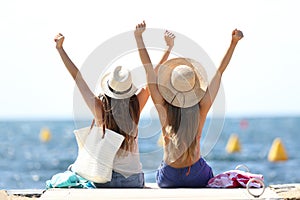 Joyful tourists on summer vacations on the beach photo