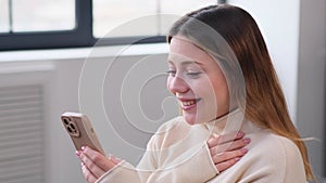 Joyful Woman Browsing Internet Or Messaging In Social Media Using Phone At Home