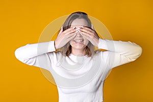 Joyful Woman Covering Eyes with Hands