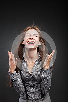 Joyful woman with flying hair and wind in her face.