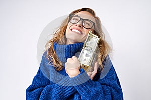 Joyful woman holding piggy bank and money