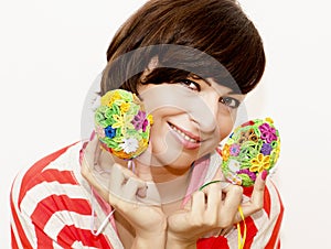 Joyful woman holding two colorful easter eggs