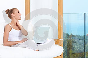 Joyful woman laughing with laptop